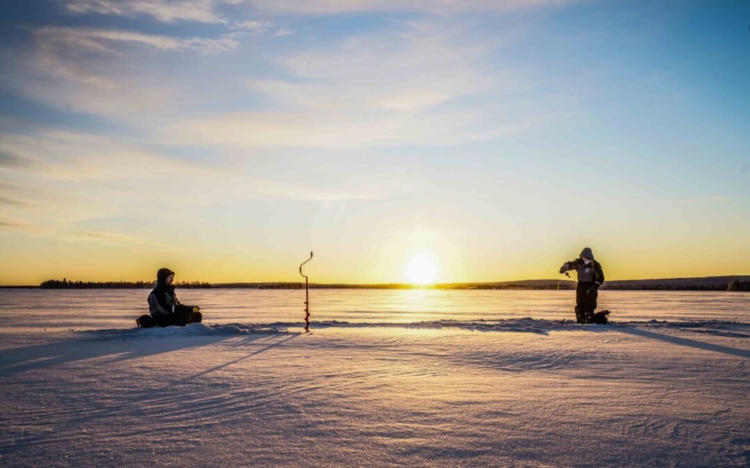 Ice Fishing on frozen lake in Levi