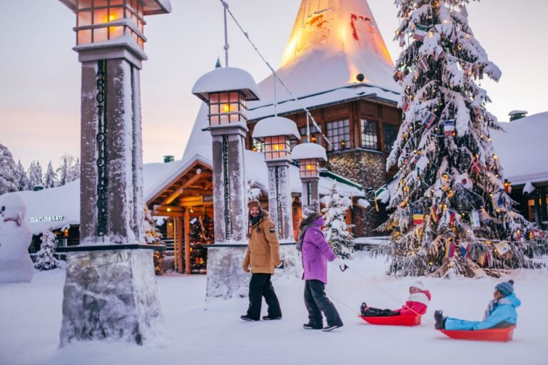 Family crossing the arctic circle at Santa Claus Village in Rovaniemi Lapland Finland